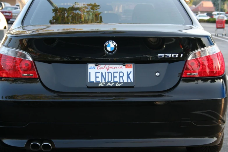 a close up of a black bmw car with an license plate