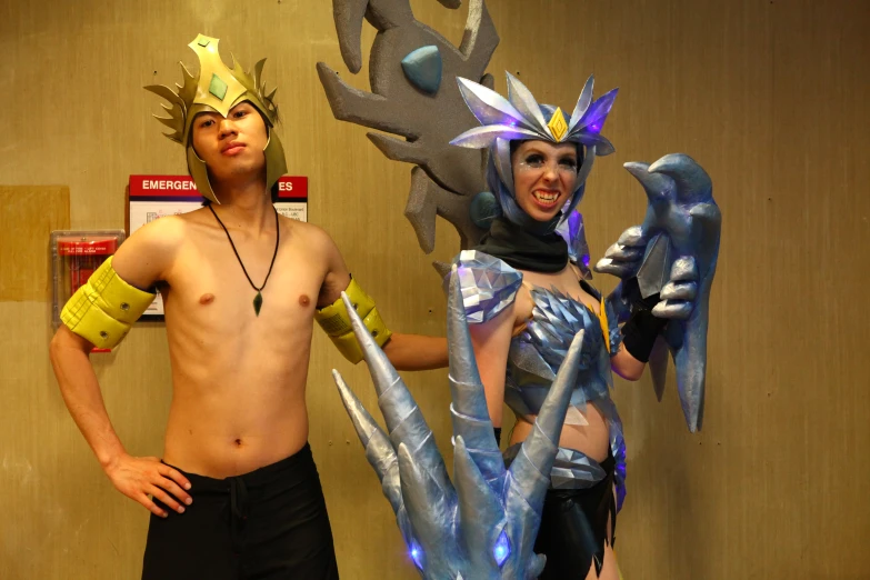 two people wearing costumes are posing with one another