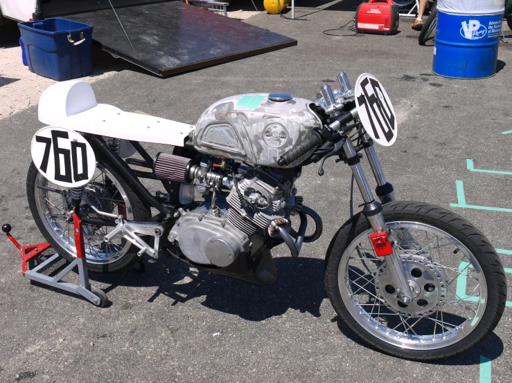 a motorcycle with an odd engine that is parked in a parking lot