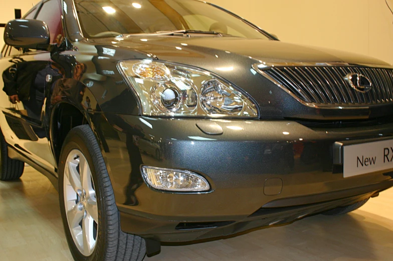 a grey suv on display in an upscale showroom