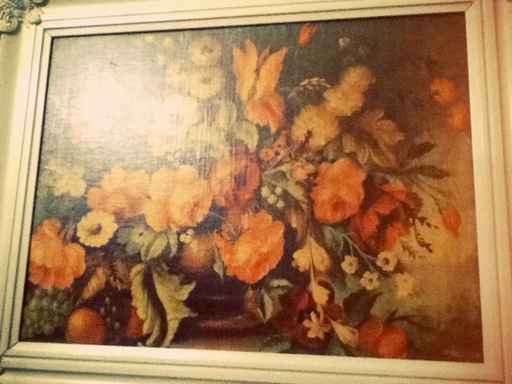 a painting of yellow flowers in a white frame