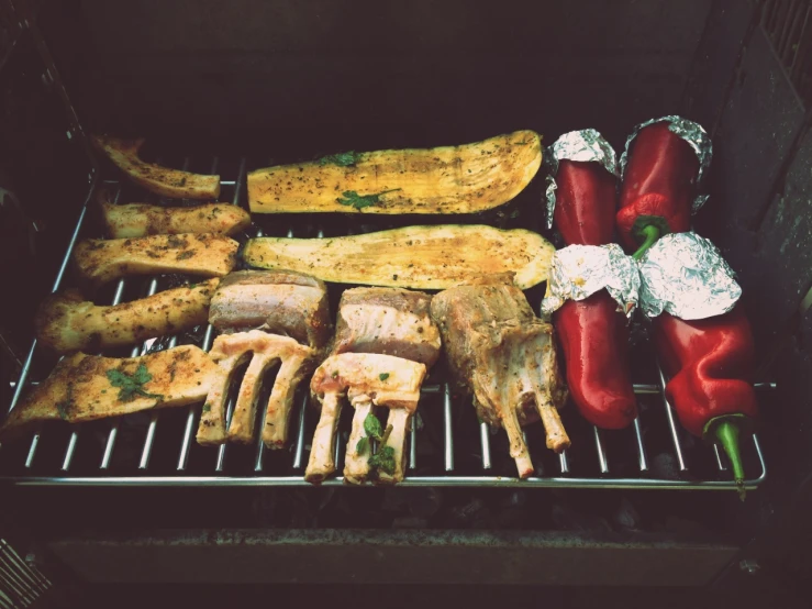 grilled chicken and vegetables cooking on a grill