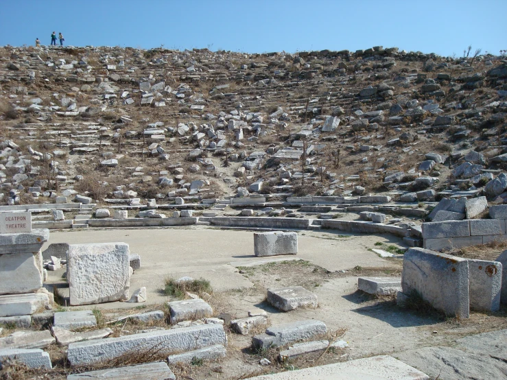 a group of rocks and benches are set in the dirt