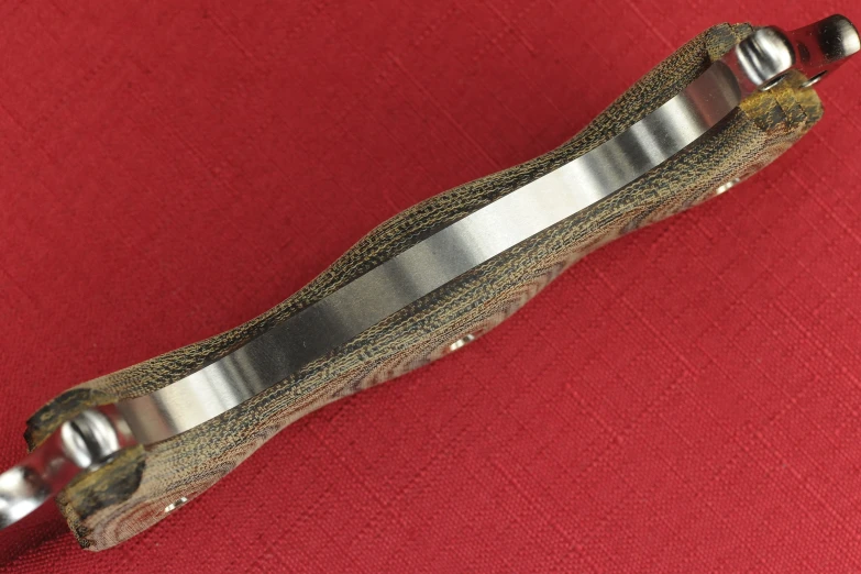 a closeup of a red material with metal tips