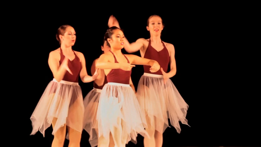 a group of women wearing tulle skirts on stage