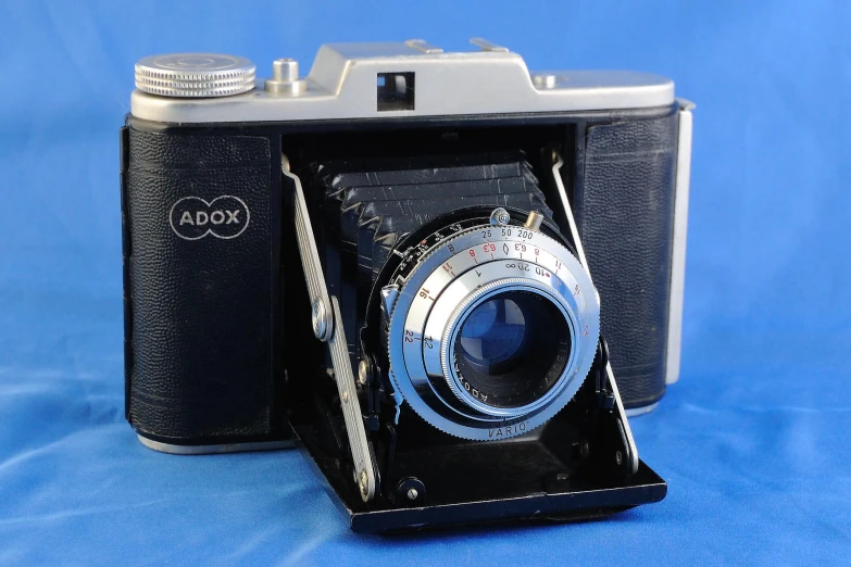 an old camera on blue backdrop with a nice reflection