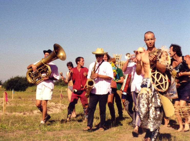 men holding instruments and standing in a field