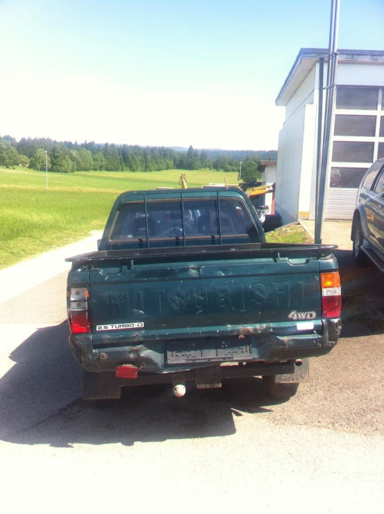 an older pickup truck parked by a house