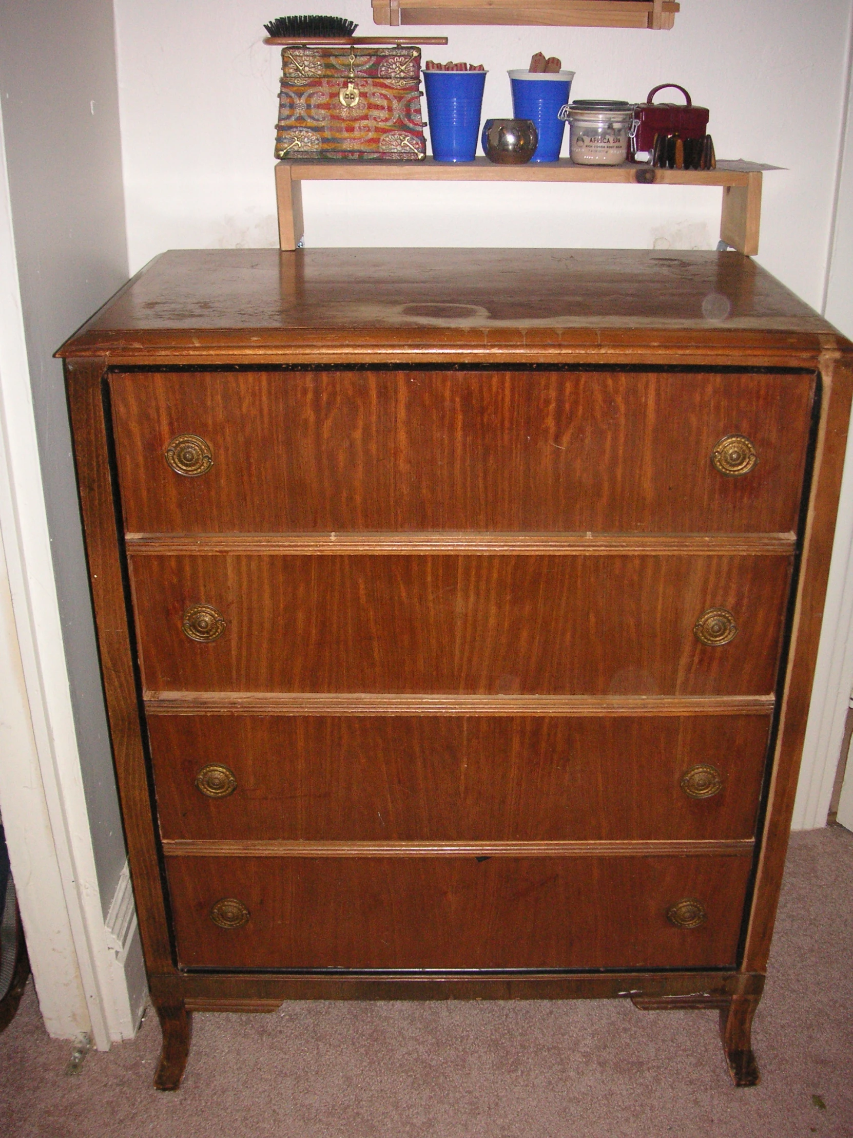 a dresser with many drawers and baskets on top of it