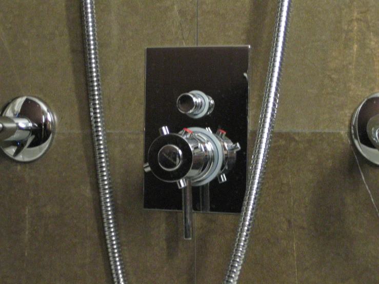 the two valves in the shower are showing their corresponding functions