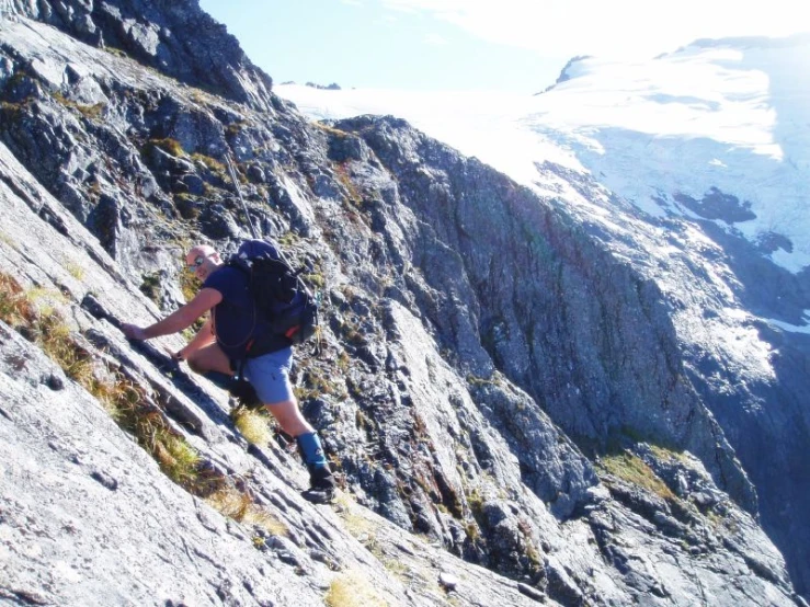 a hiker hiking up the side of a mountain