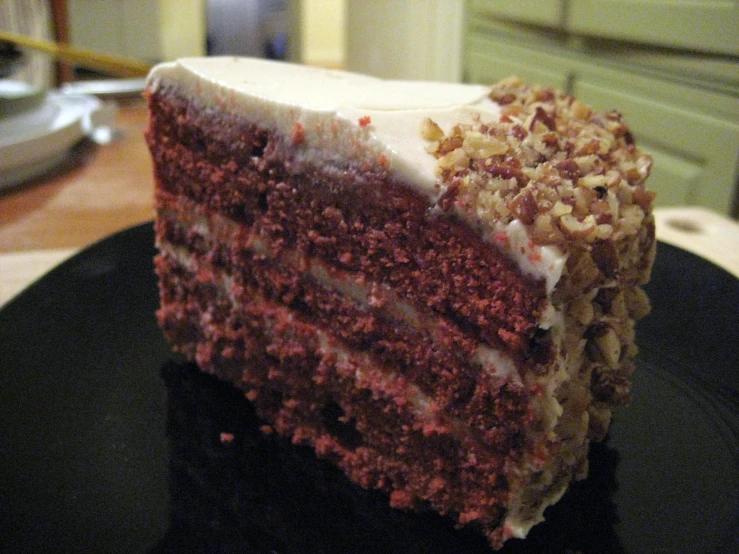 a slice of red velvet cake with white frosting