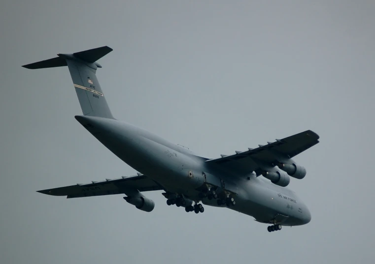 the airplane is ascending into the air in the gray sky