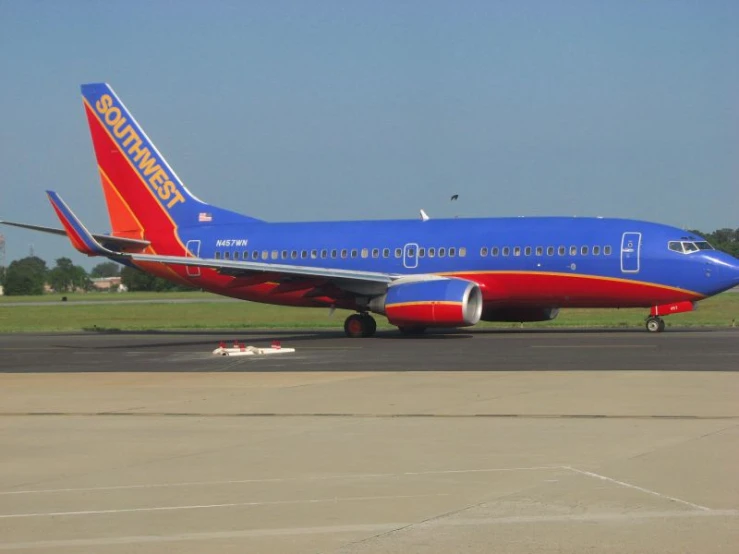 a large blue and red airplane is at the airport