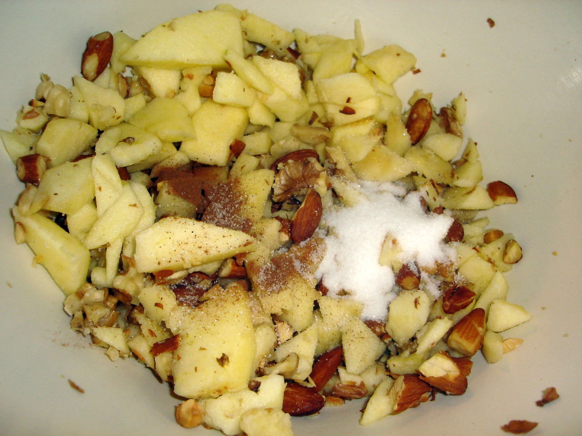 chopped up fruit and nuts in a bowl