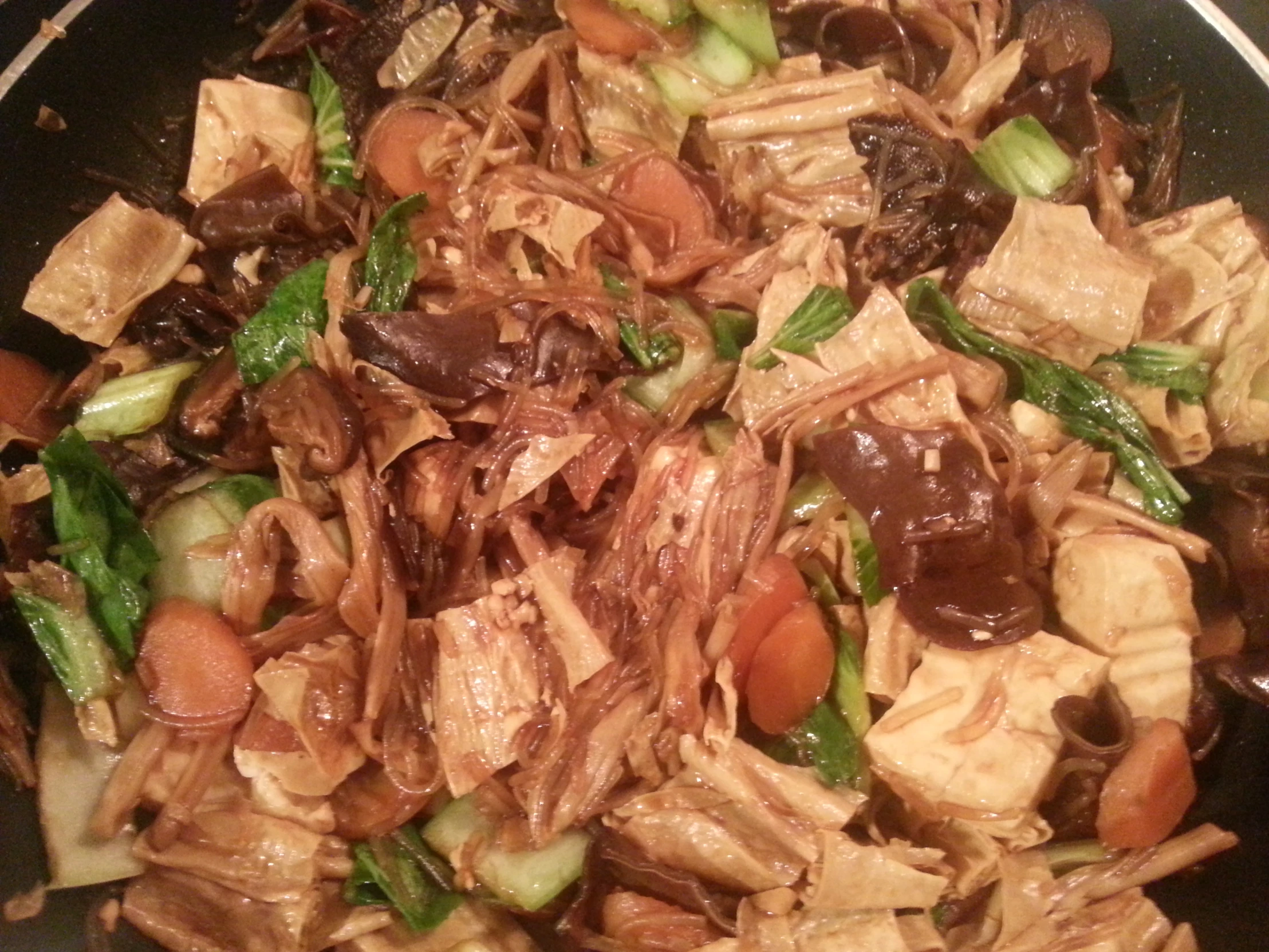 a plate of meat, vegetables and sauce in a bowl