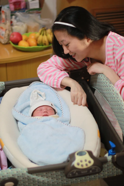 a mother feeds her baby in the car seat