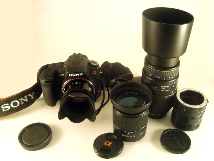 camera equipment displayed on white surface with lens cap and lens cap