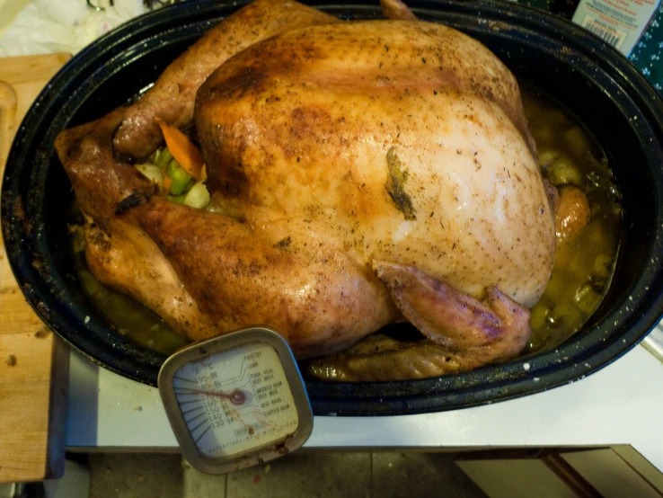 a turkey roast in a large pot is being cooked