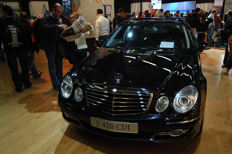 a mercedes benz car is displayed at a show
