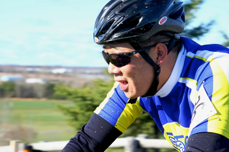 the cyclist smiles while riding his bike