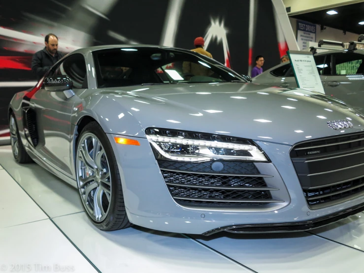 the front view of a grey car is shown on display