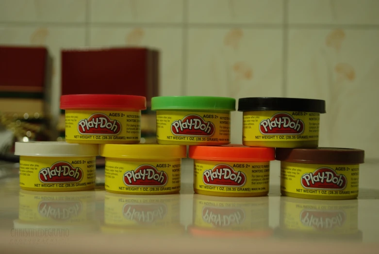 seven plastic and foam jars on a kitchen counter