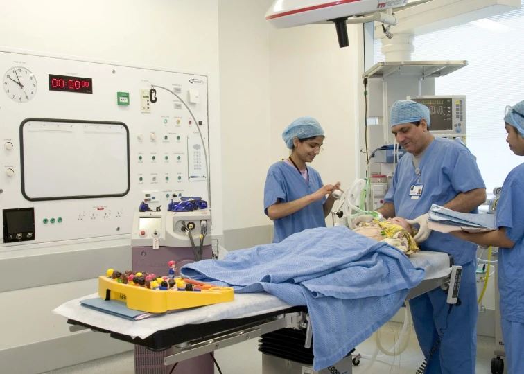 a group of doctors looking at soing in a room