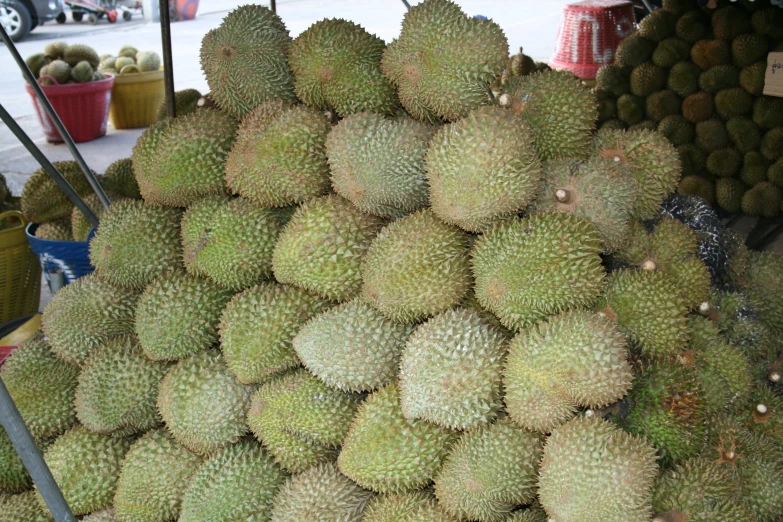 a big pile of green fruit that is for sale