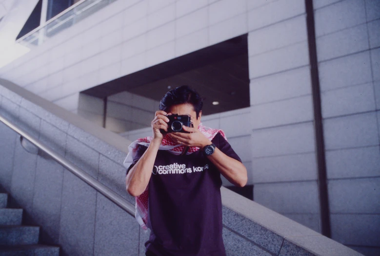 a man with his hands on his camera taking a picture