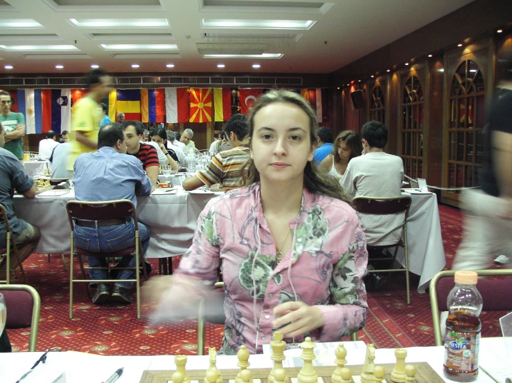 a woman playing chess in an oriental style restaurant