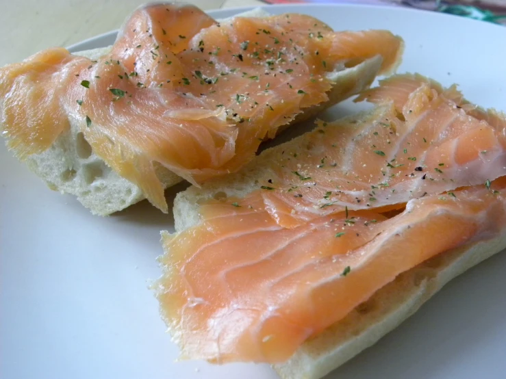 two pieces of bread that are covered with smoked salmon