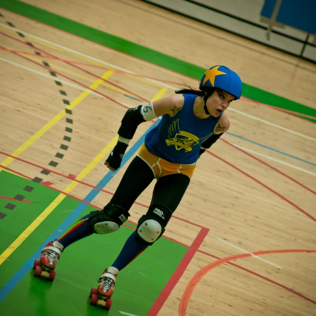a man wearing roller blades in a blue shirt and black pants