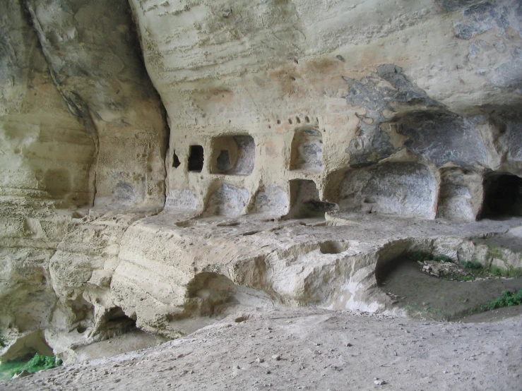 a rocky mountain has cave like structures inside of it