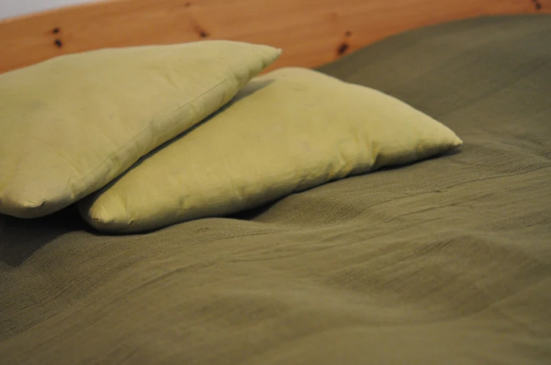 two pillows that are sitting on top of a bed