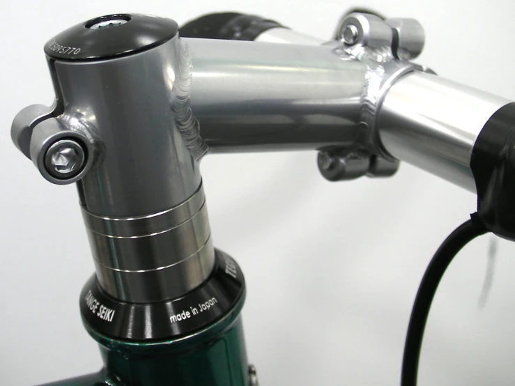 the top section of a chrome colored bike handle