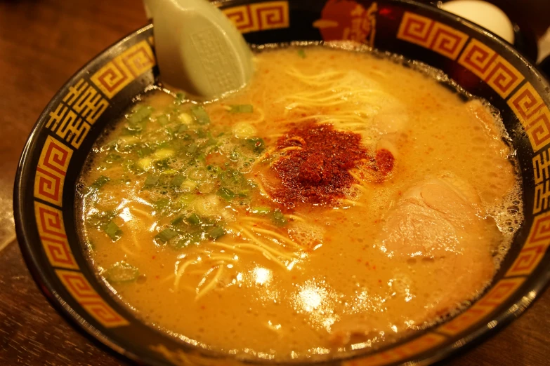 a bowl full of food that includes noodles and meats