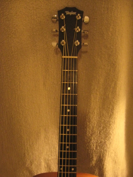 the back and neck of a guitar with a string