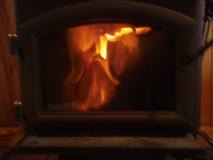 a wood burning stove in a wooden wall