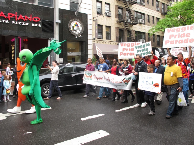 people march in the street carrying large signs