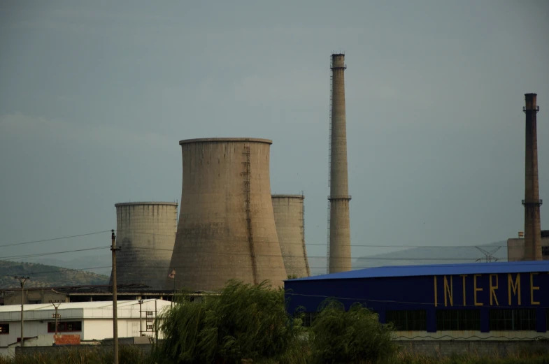 a large power plant sits on a hill