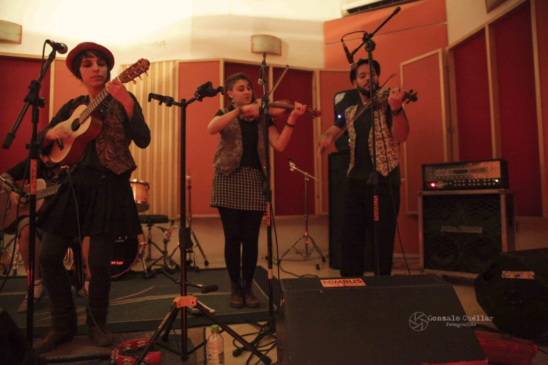 a group of young people are playing musical instruments