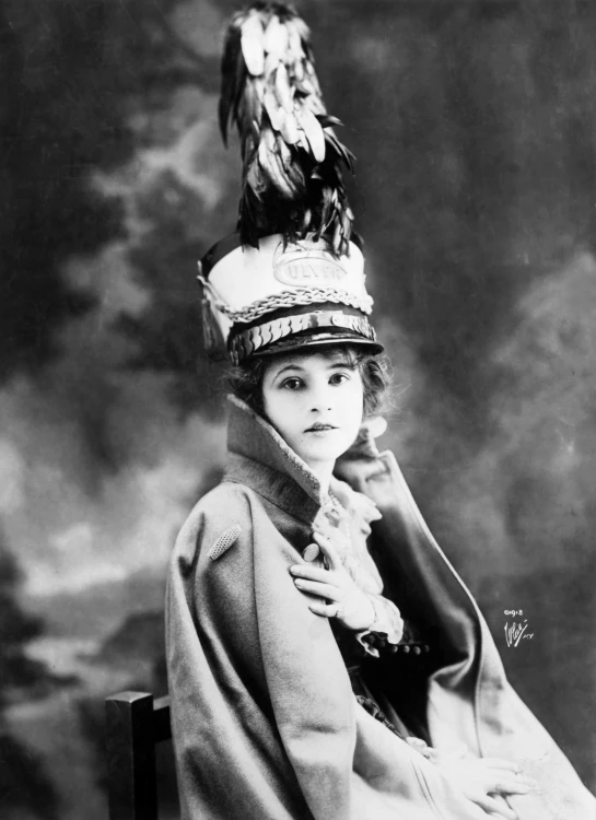 an old time po of a young lady wearing a bird hat