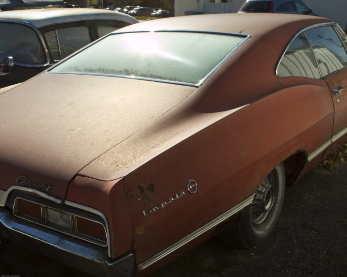 old brown cars parked in a lot next to each other