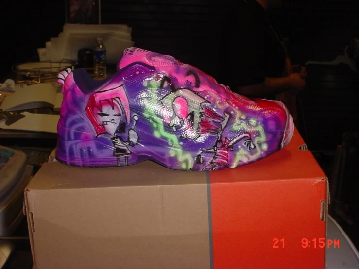 a pair of shoes with graffiti painted on them