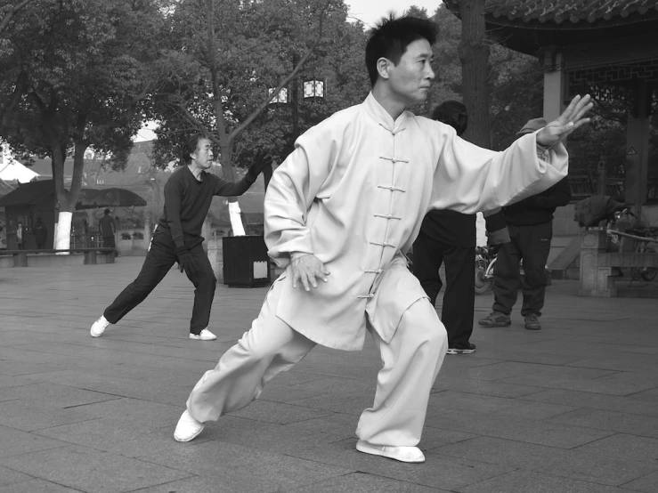two men are in the street doing martial moves