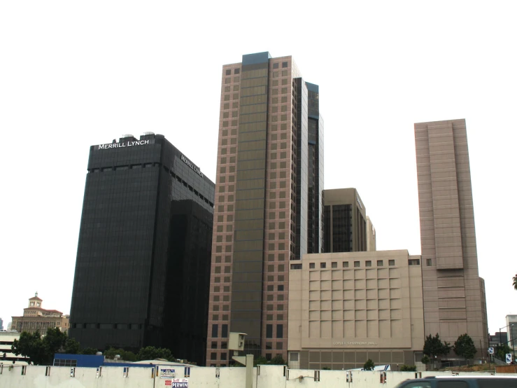 some buildings on a cloudy day and buses