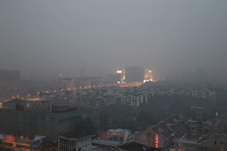 a city on a foggy evening with buildings