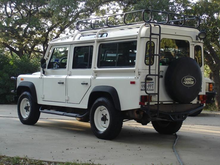 this is a large white automobile that has an open roof