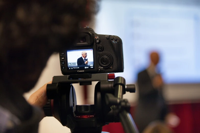 a person taking a picture of soing on a camera